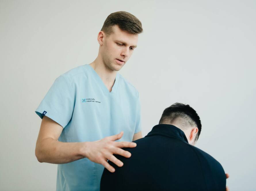 Massage therapist reassuring his client