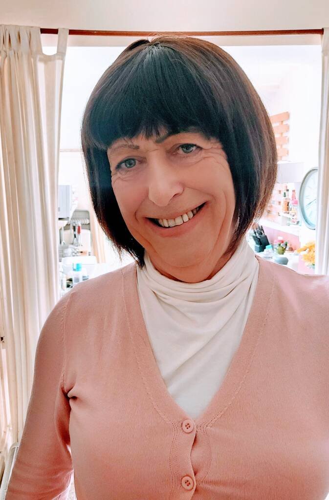 Dressing up_ Mobile massage near you | Blissful Serenity Harmony wearing her pink cardigan